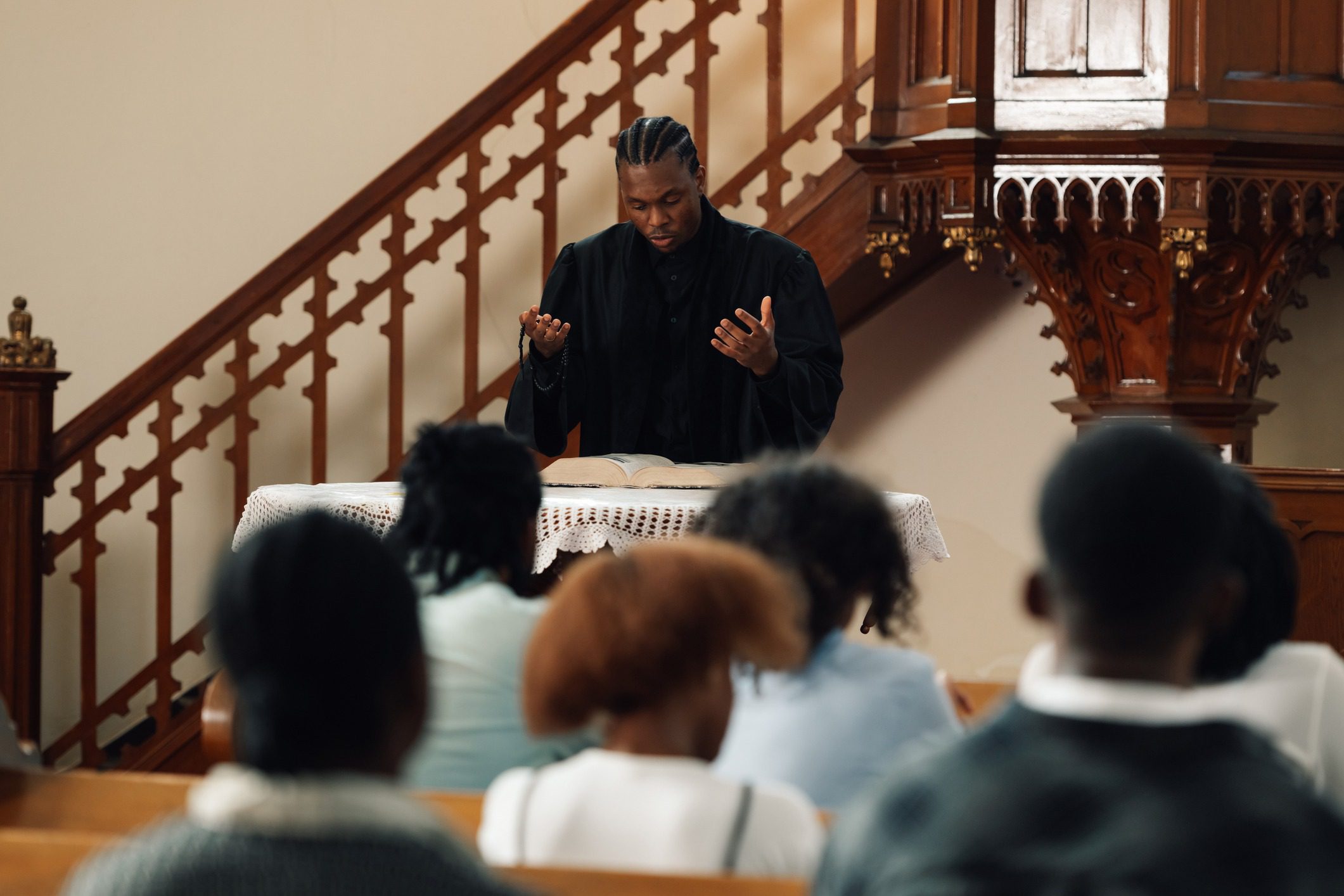 Preacher speaking to congregation in church.