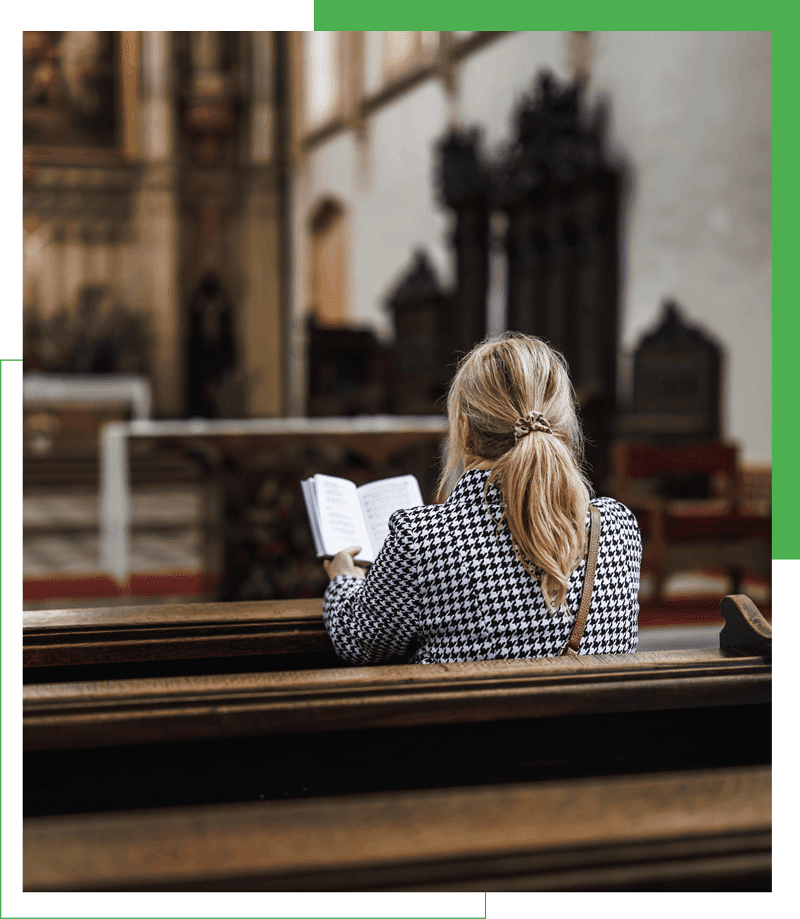 Woman reading in a church pew.