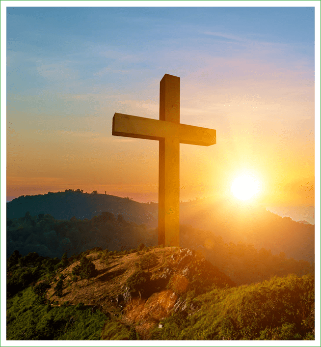 Cross on hill during sunset.
